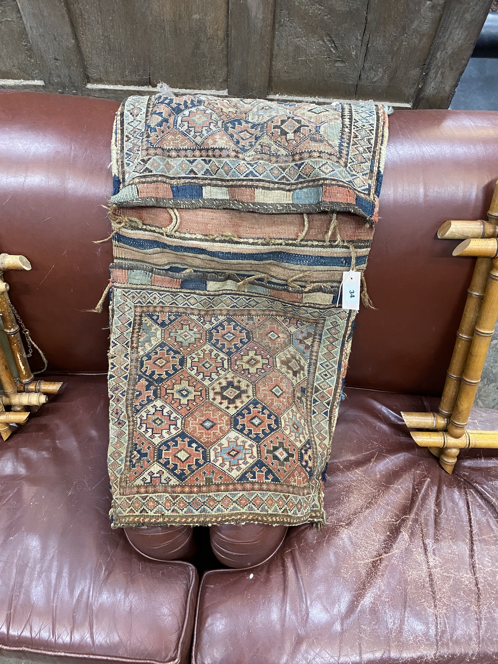 A Caucasian geometric red ground saddlebag, 107 x 48cm